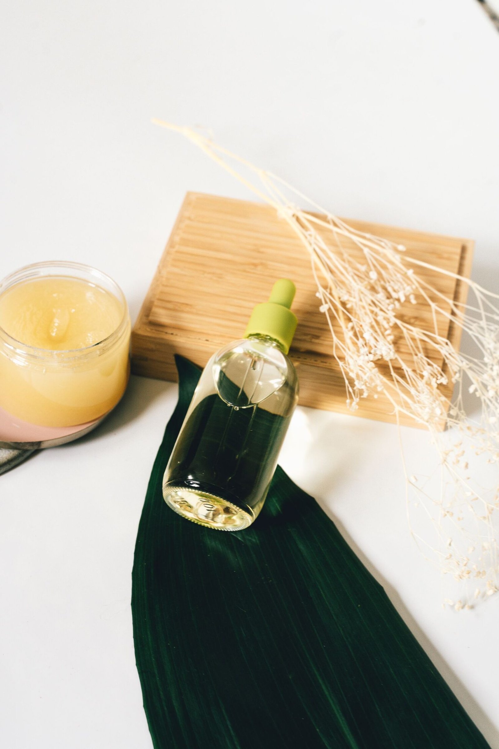 Elegant natural skincare bottles and jars with botanical accents