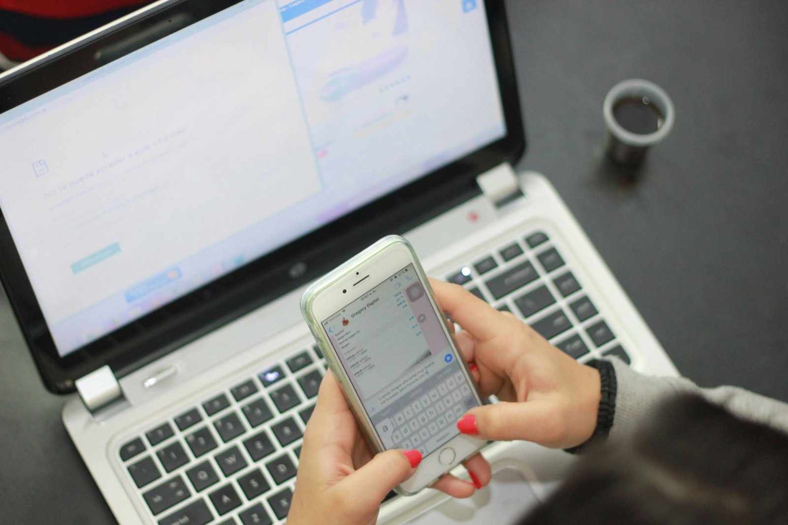 Person using a smartphone beside a laptop for everyday digital communication