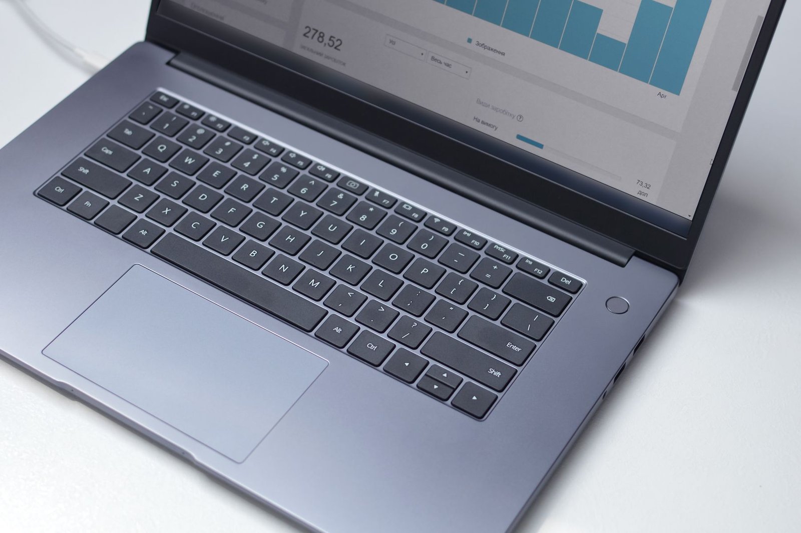 Laptop displaying an analytical software interface in a modern digital workspace